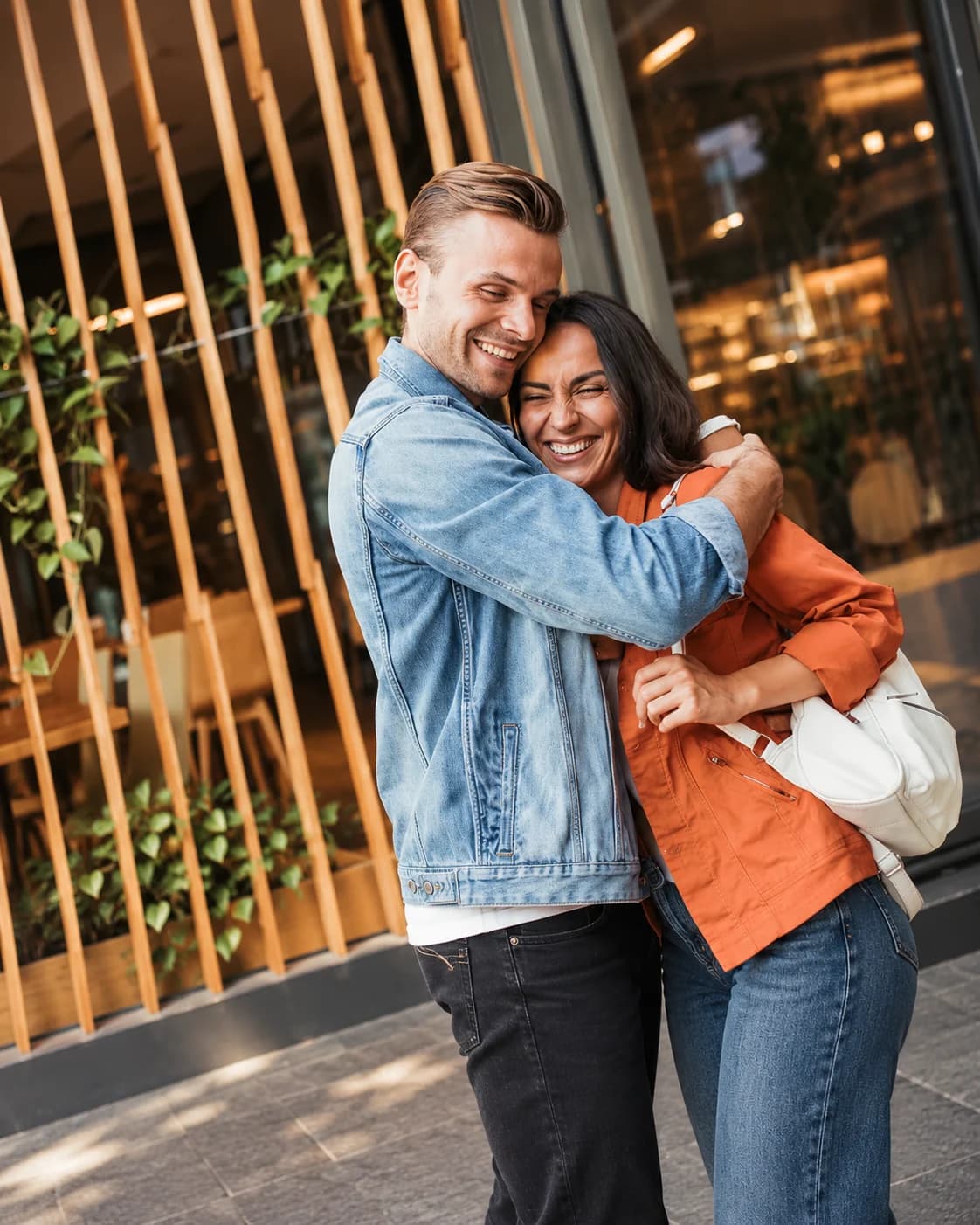 Couple embracing outside a cafe